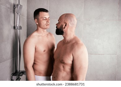 nude men showering together