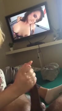 handjob watching tv