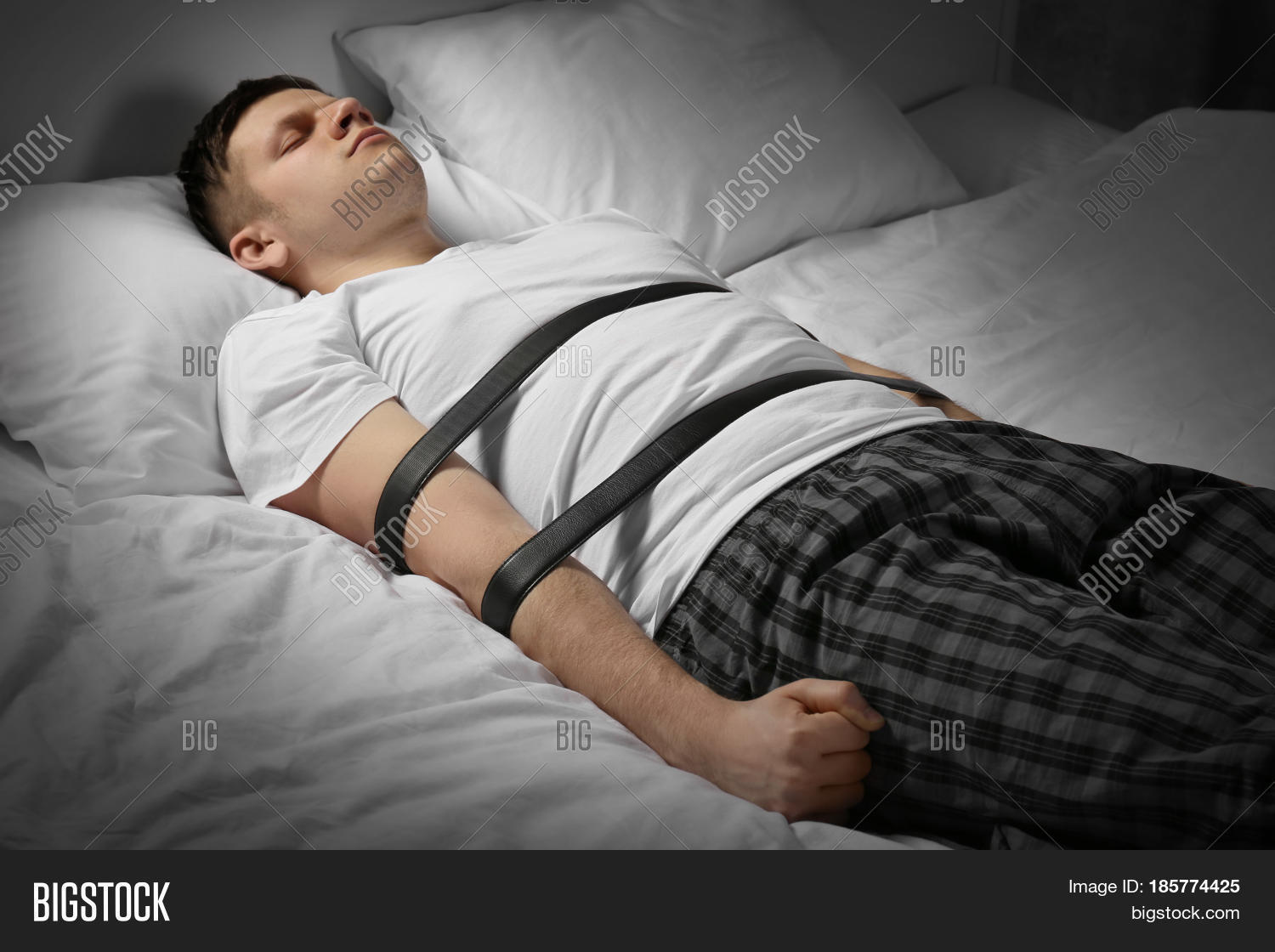 guy tied to a bed