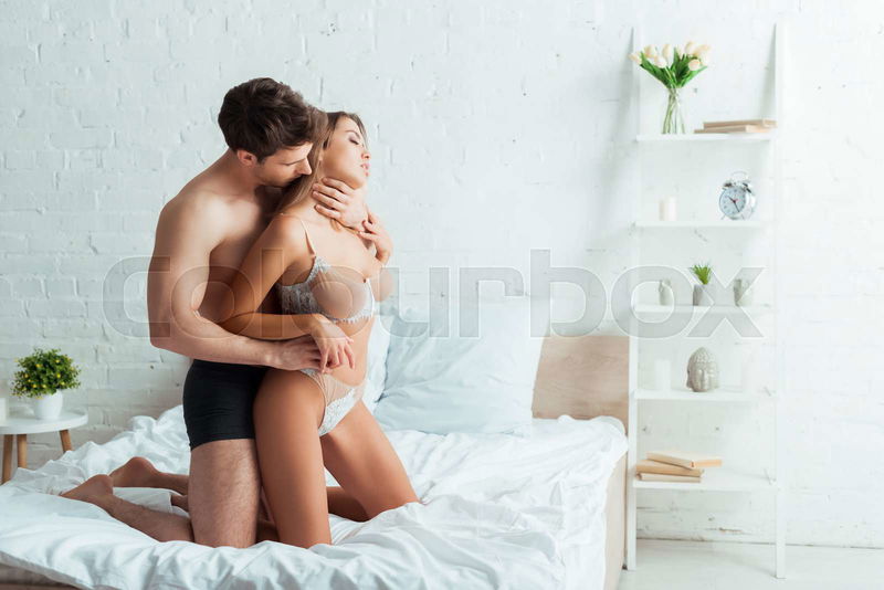 man kissing woman breast